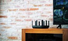 router on wooden stand against brick wall