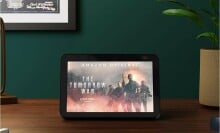 an amazon echo show sits on a tabletop showing a movie title screen