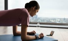 a person doing yoga wears the samsung galaxy watch 6