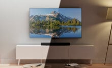 Amazon QLED TV on TV stand with light hitting half of the TV