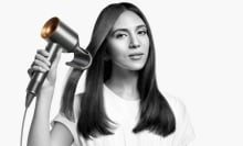 woman uses dyson supersonic with flyaway attachment on her hair