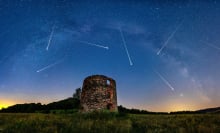 Meteors in the sky above some ancient ruins