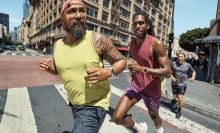 two people running across city street wearing fitbit charge 6