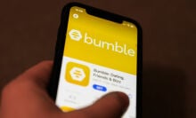 Bumble dating app logo on the App Store is seen displayed on a phone screen