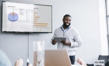 man presenting data at a meeting