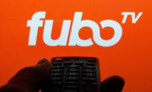 TV remote control is seen with fuboTV logo displayed on a screen in this illustration photo taken in Krakow, Poland on February 6, 2022.