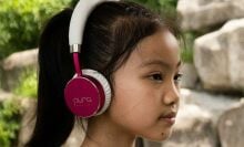 young girl wearing Puro Sound Labs headphones
