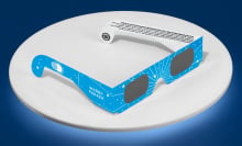 warby parker eclipse glasses on a white and blue background