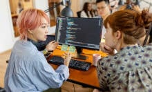 Two women on computer discussing cybersecurity