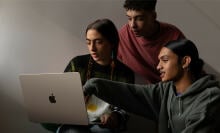 three people looking at m2 macbook air