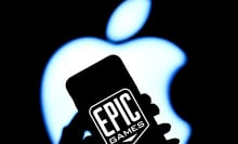 Epic Games logo on iPhone with Apple logo in the background