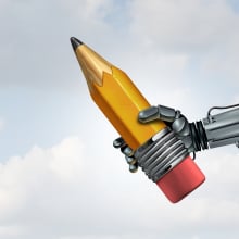 a robot holds a pencil