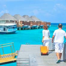 people carrying suitcases on a dock