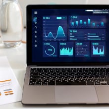 laptop displaying data graphics