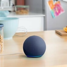 an amazon echo dot sits on a kitchen countertop 