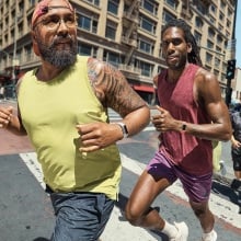 two people running across city street wearing fitbit charge 6