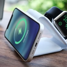 smartphone and Apple Watch on folded charger stand