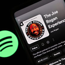 In this photo illustration, "The Joe Rogan Experience" podcast is viewed on Spotify's mobile app