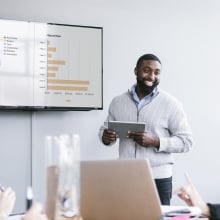 man presenting data at a meeting