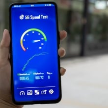 Person holding a phone with speed test
