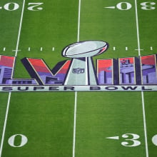 Super Bowl LVIII logo on the football field.
