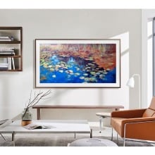 a samsung the frame TV sits above a table in a living room