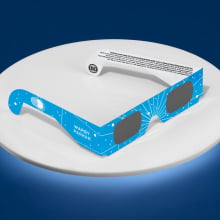 warby parker eclipse glasses on a white and blue background