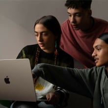 three people looking at m2 macbook air