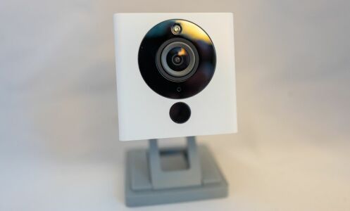 A surveillance camera from smart home company Wyze isolated on white background.