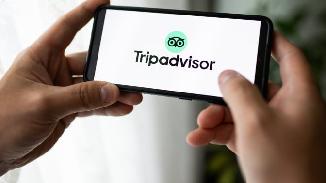 A Tripadvisor logo seen displayed on a smartphone