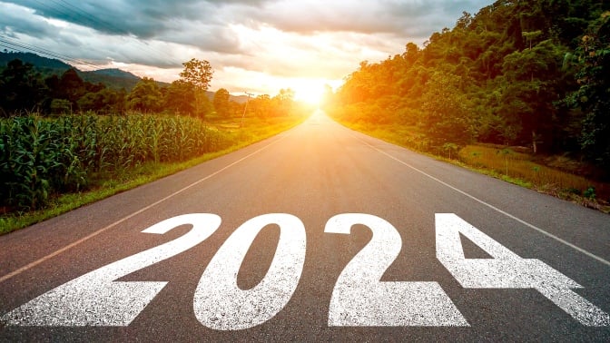 2024 written on a road heading towards the sun.