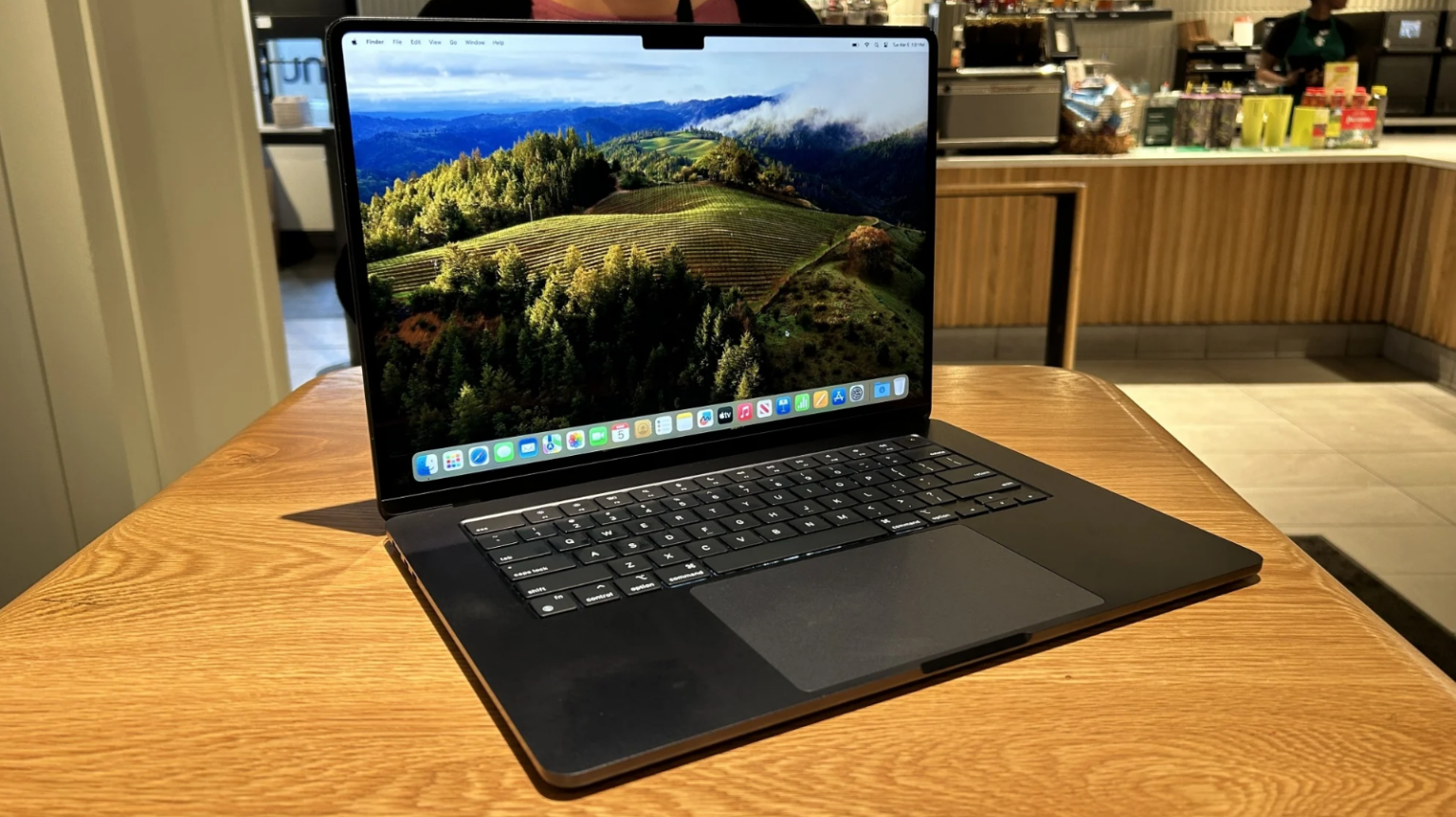 a 15-inch m3 apple macbook air sitting on a wooden table in starbucks