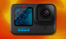 GoPro HERO11 action camera on orange and yellow abstract background