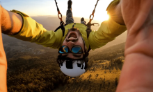 Man skydiving upside-down in the sunlight 