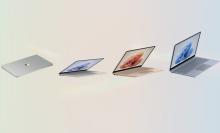 four microsoft surface laptop go 3s against a rainbow pastel background