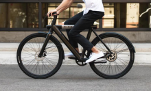 close up of waist down of man riding Bird e-bike on street 