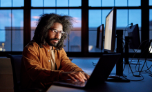 man with glasses and beard working on windows desktop computer