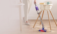 person vacuuming floors with Dyson Omni-Glide vacuum