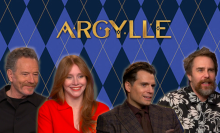 Bryan Cranston, Bryce Dallas Howard, Henry Cavill, and Sam Rockwell in front of an ‘Argylle’ wallpaper.