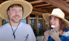 MrBeast in a wide brimmed straw hat next to friend Kris Tyson