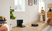 Roomba i5 cleaning hardwood floor with furniture and dock in peripherals