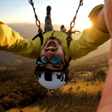 Man skydiving upside-down in the sunlight 