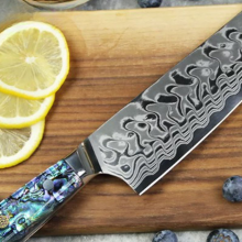 Ryori chef knife laying on cutting board with fruits and vegetables