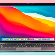 the m1 apple macbook air against a pastel pink and blue background