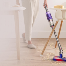 person vacuuming floors with Dyson Omni-Glide vacuum