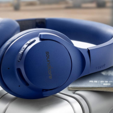 Soundcore Life Q20 headphones laying on suitcase with passport
