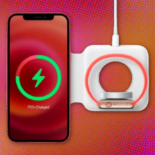 apple's magsafe duo charger charging an iphone and an apple watch against a red and orange abstract background