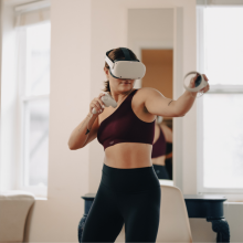 woman in workout clothes wearing VR headset 
