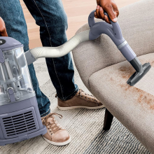shark vacuum attachment cleaning a chair 